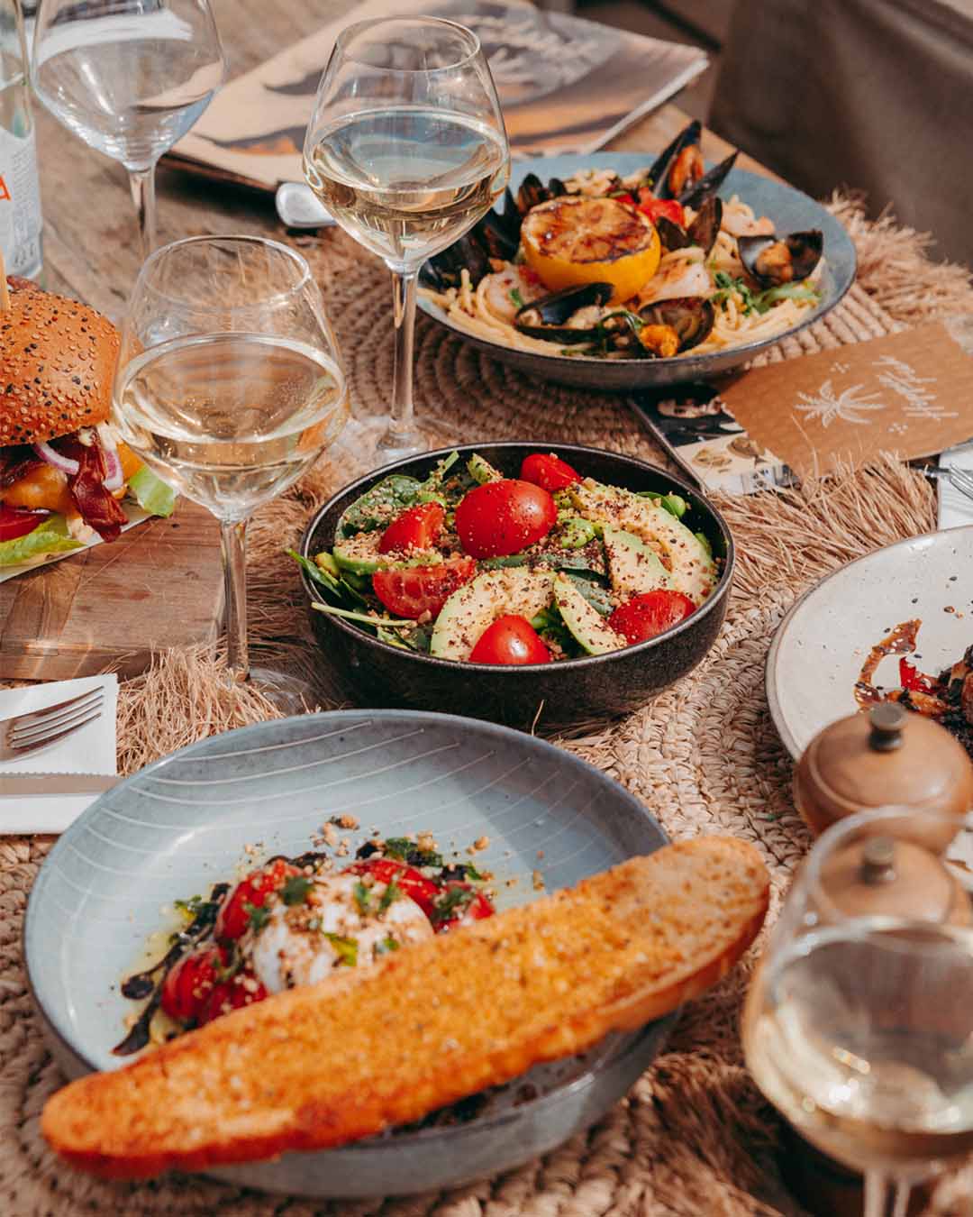 Gedekte tafel met diverse diner-gerechten bij Hippie Fish Zandvoort